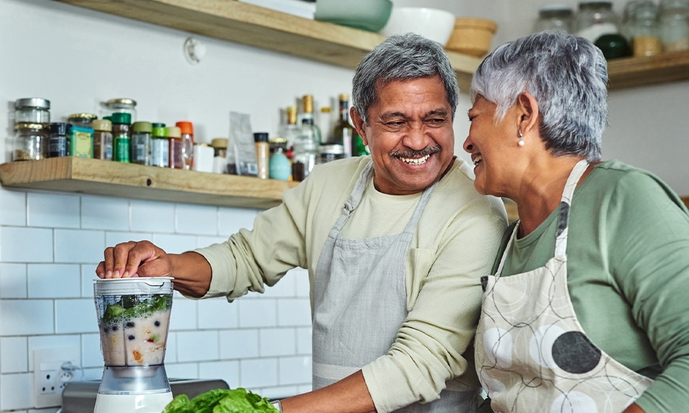 a man and woman preparing food in a kitchen