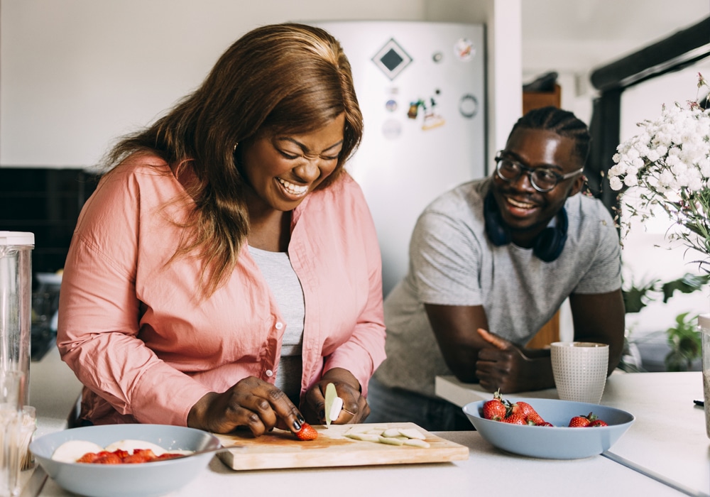 a woman sitting at a table with a plate of food